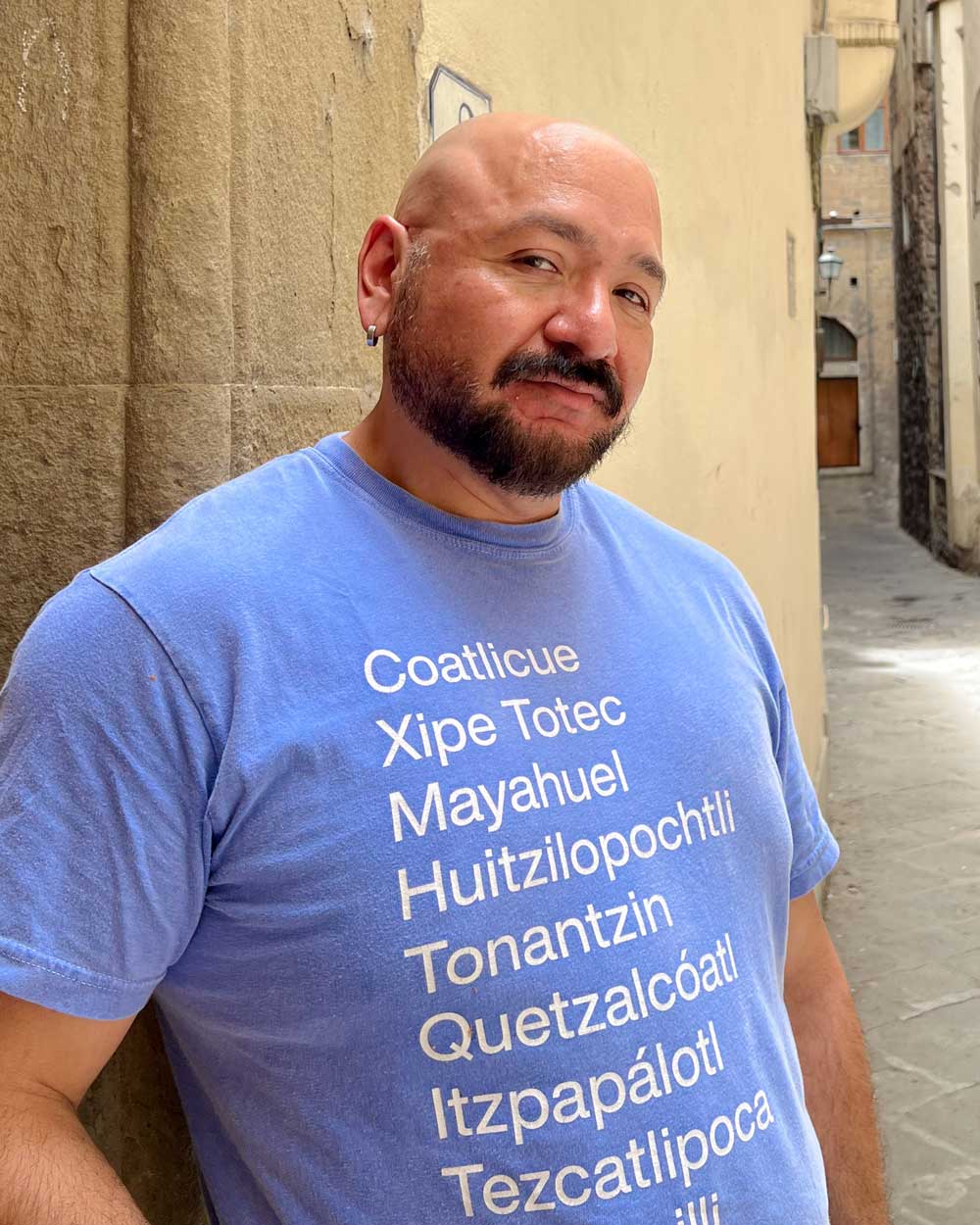 Cesar Torres wearing The Deities of the Coil Tee, photographed in Italy