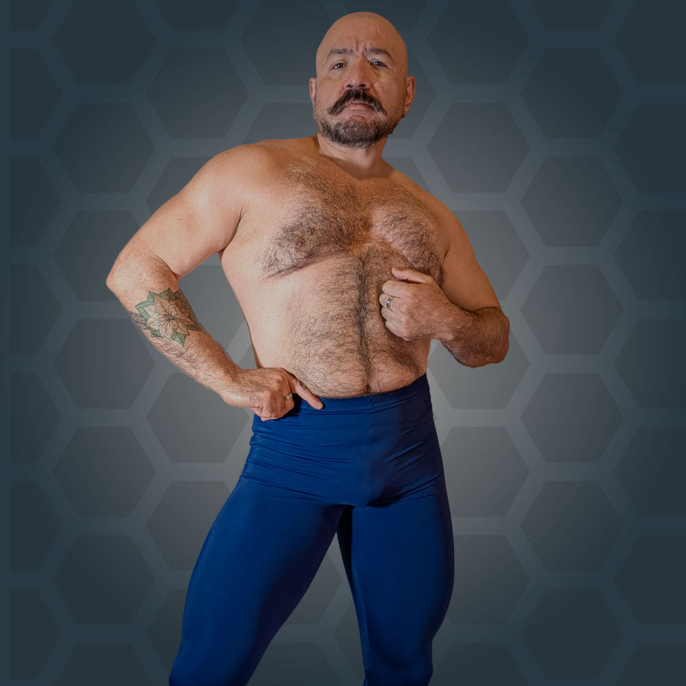 Model wearing Midnight Cobra tights in deep blue, hands at the waistband, front view