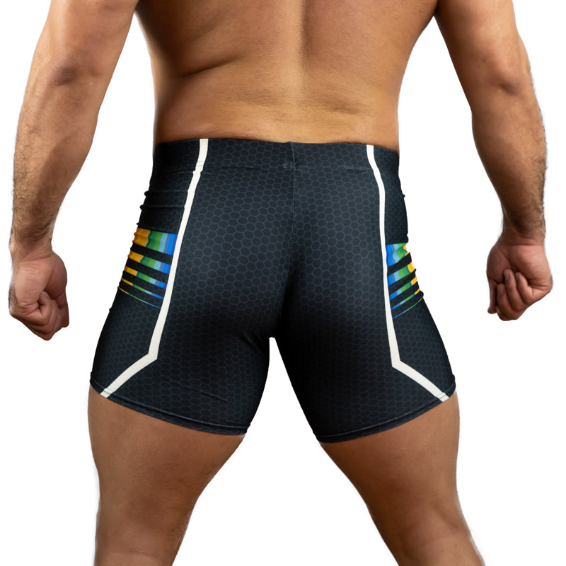 Rear view of a man wearing dark athletic compression shorts with a subtle honeycomb pattern, white side panels, and colorful striped accents on the hips.